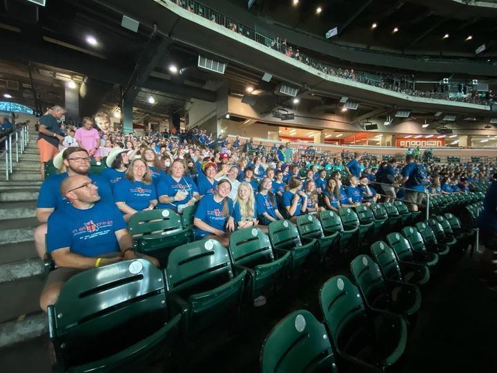 students and members sitting at game